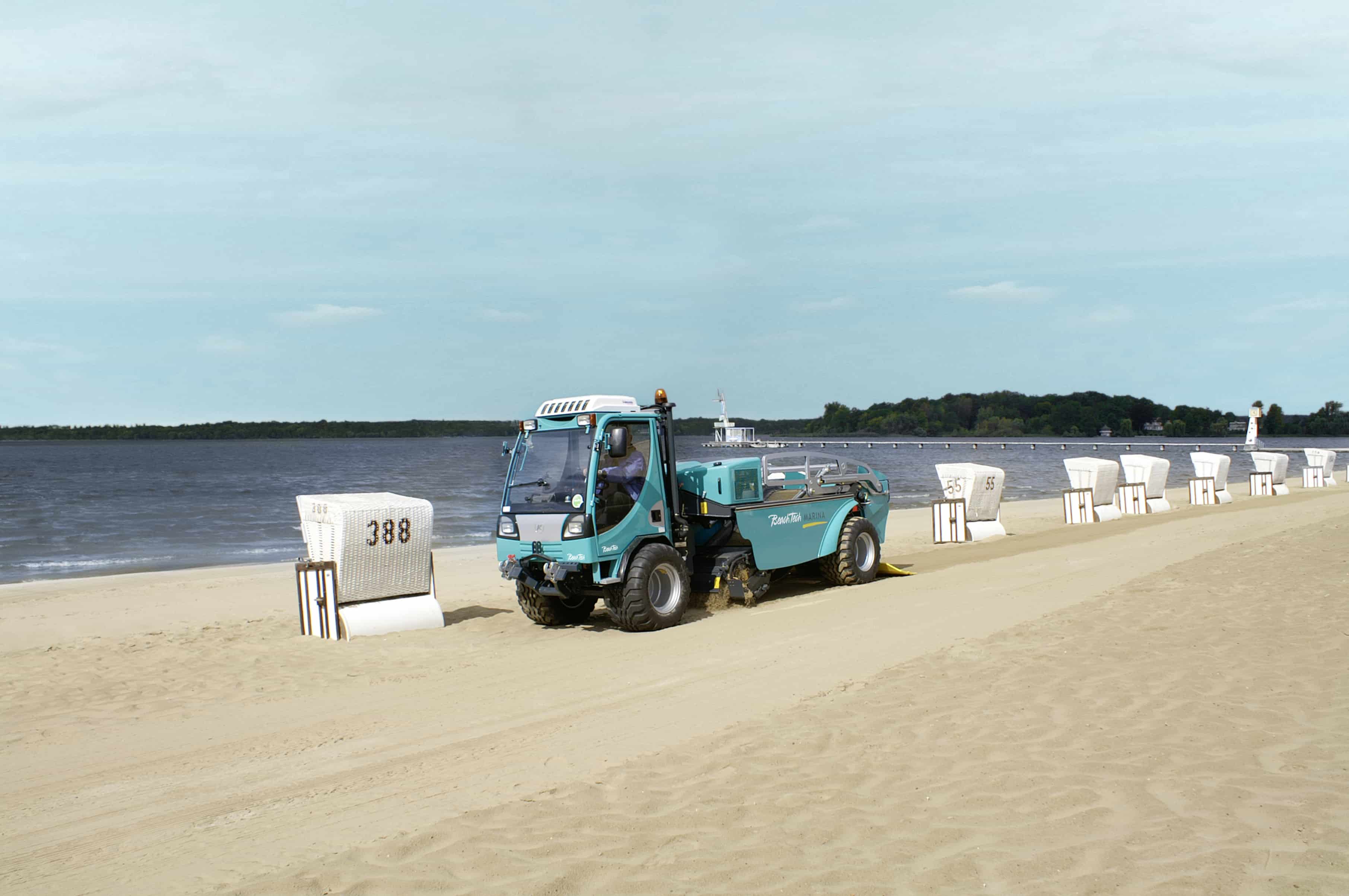 Beach cleaner BeachTech Marina on the beach with beach chairs 