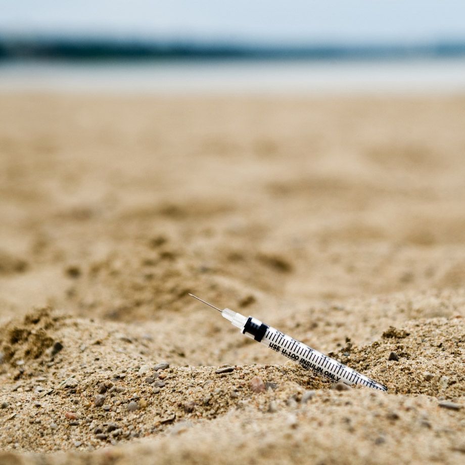 Syringe in sand