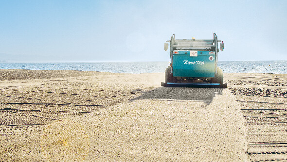Trailed beach cleaner with tractor on beach