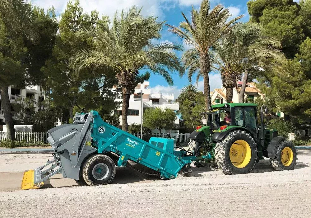 The tractor towed beach cleaner BeachTech 2500 on the beach. 