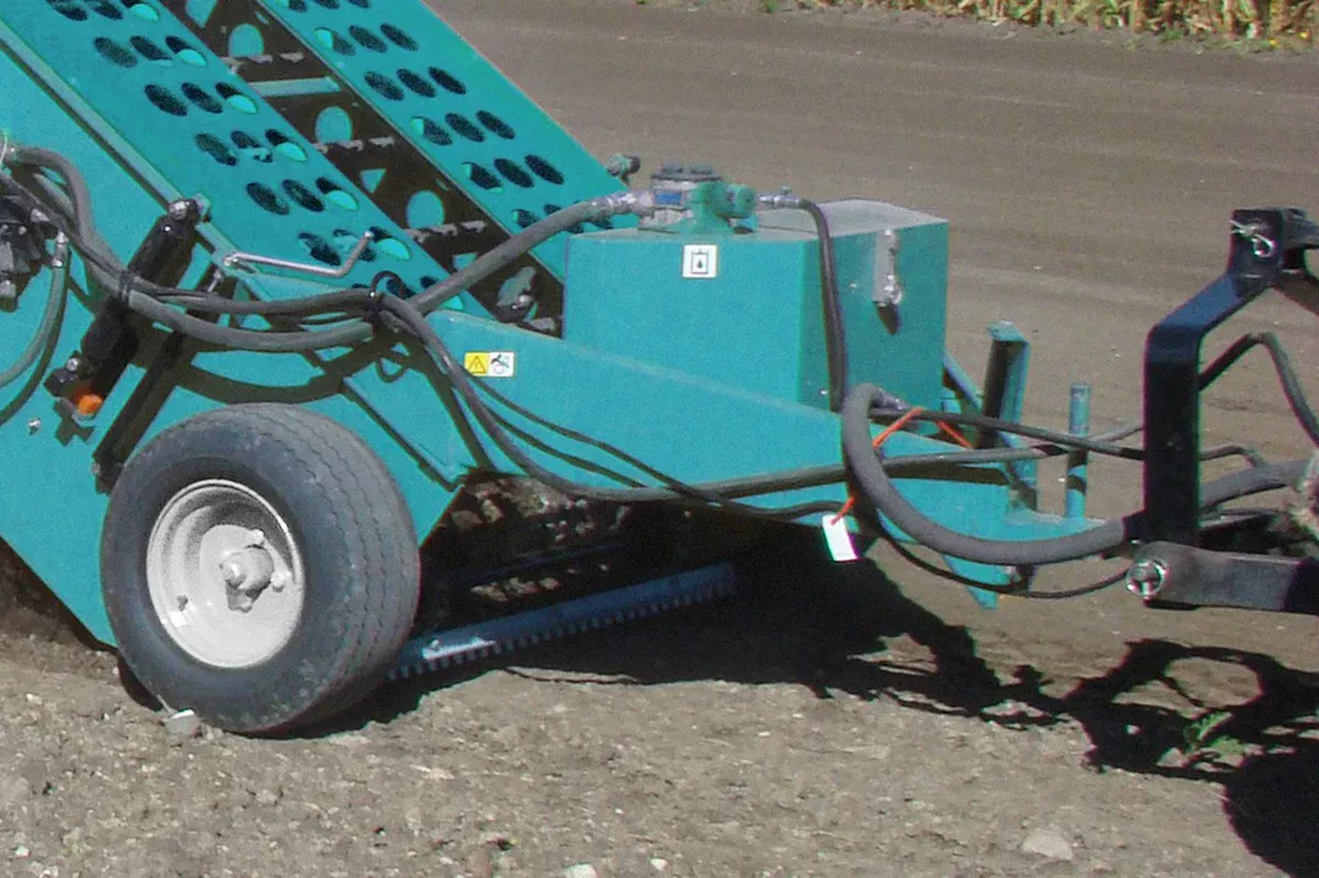 Towed Beach Cleaner BeachTech 1000 with tractor side view on street 